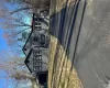 View of front of property with asphalt driveway, large yard and front Sunroom View of front of property with asphalt driveway, large yard and front Sunroom