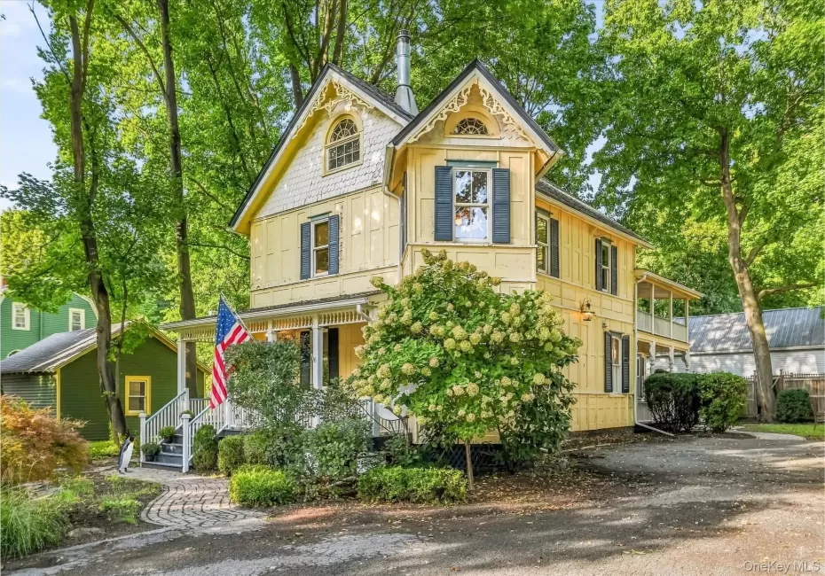 Victorian-style exterior with decorative gables, a covered porch, and mature landscaping Victorian-style exterior with decorative gables, a covered porch, and mature landscaping