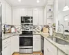 White shaker-style cabinetry, granite countertops, mosaic tile backsplash, stainless steel appliances, and an undermount sink with a gooseneck faucet White shaker-style cabinetry, granite countertops, mosaic tile backsplash, stainless steel appliances, and an undermount sink with a gooseneck faucet