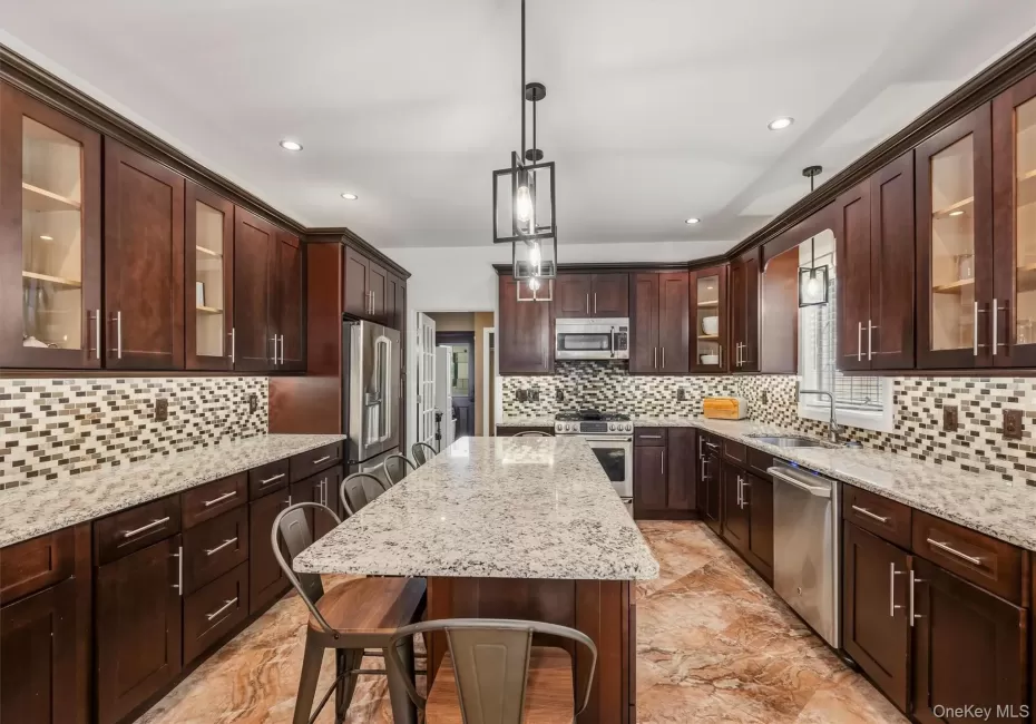 Kitchen with 7 foot 7 inch center island that seats 6, Anderson casement window above sink, Cafe appliances, granite countertops, tile backsplash, uplighting, Recessed lighting, marble tile floors and 9 foot ceilings. Kitchen with 7 foot 7 inch center island that seats 6, Anderson casement window above sink, Cafe appliances, granite countertops, tile backsplash, uplighting, Recessed lighting, marble tile floors and 9 foot ceilings.