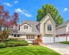 Two-story home with a gabled roof and bay window Two-story home with a gabled roof and bay window