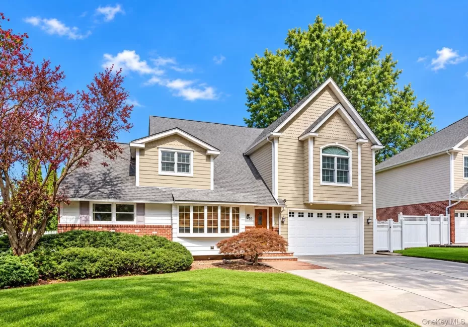 Two-story home with a gabled roof and bay window Two-story home with a gabled roof and bay window