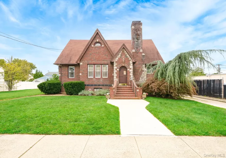 Brick exterior with stone accents, steeply pitched roof, and an arched entry Brick exterior with stone accents, steeply pitched roof, and an arched entry