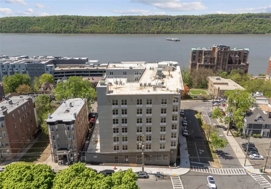 Drone / aerial view of a nearby body of water and a forest Drone / aerial view of a nearby body of water and a forest