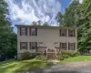 Two-story duplex with light-colored siding and red shutters Two-story duplex with light-colored siding and red shutters