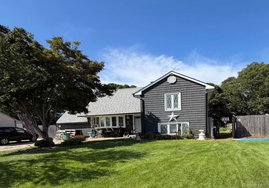 Shingle siding exterior with white trim, a gabled roof, and multiple windows Shingle siding exterior with white trim, a gabled roof, and multiple windows