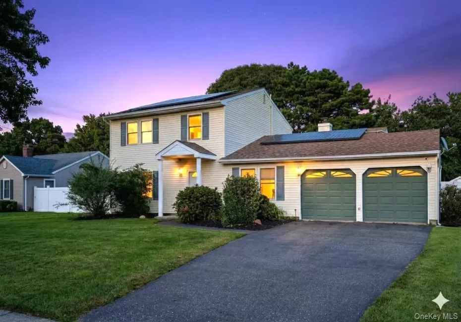 Two-story residence with siding exterior, attached two-car garage, established landscaping, and a paved driveway. AI edited. Two-story residence with siding exterior, attached two-car garage, established landscaping, and a paved driveway. AI edited.