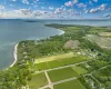 Aerial overview of property's location featuring property parcel outlined and a large body of water Aerial overview of property's location featuring property parcel outlined and a large body of water