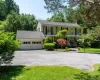 View of front of house featuring a porch, a chimney, an attached garage, driveway, and roof with shingles View of front of house featuring a porch, a chimney, an attached garage, driveway, and roof with shingles