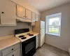 Electric stove, window, wood look laminate flooring Electric stove, window, wood look laminate flooring