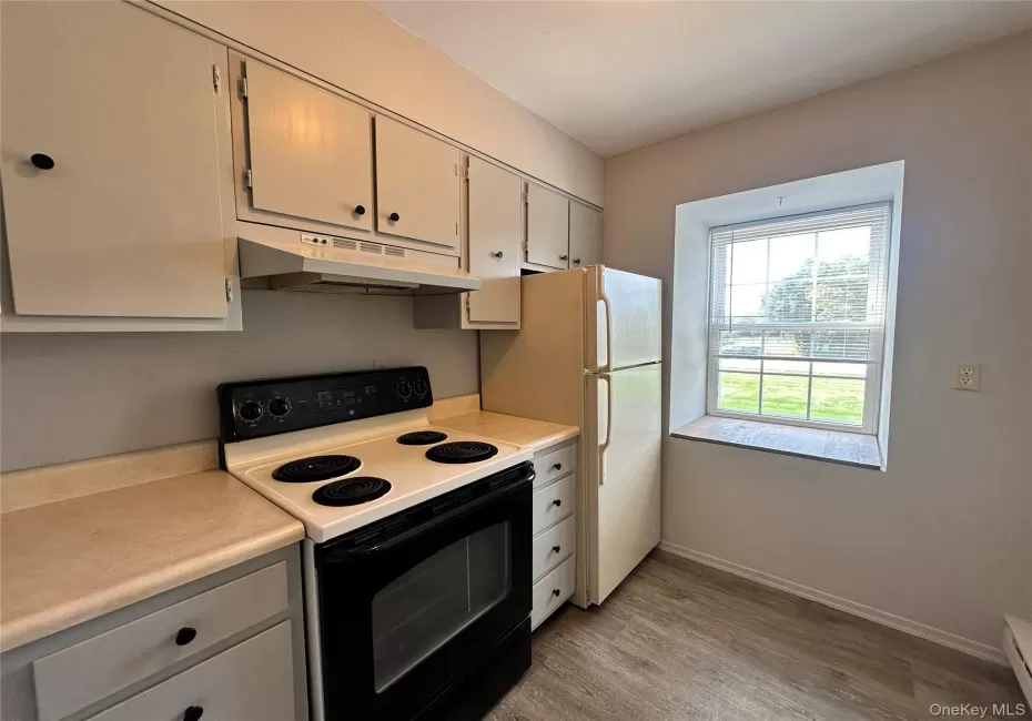Electric stove, window, wood look laminate flooring Electric stove, window, wood look laminate flooring