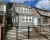 Gray siding exterior, white-framed windows, and a white front entry door with transom window detail Gray siding exterior, white-framed windows, and a white front entry door with transom window detail