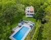View of subject property featuring a forest and a pool View of subject property featuring a forest and a pool