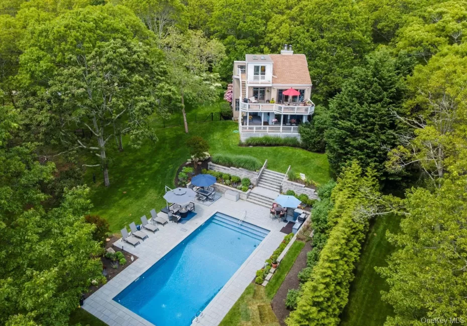 View of subject property featuring a forest and a pool View of subject property featuring a forest and a pool