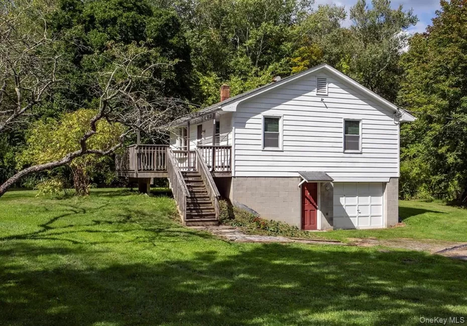 Side of home with Steps to Deck and main enterance.Additional Entry door to garage/basement. Side of home with Steps to Deck and main enterance.Additional Entry door to garage/basement.