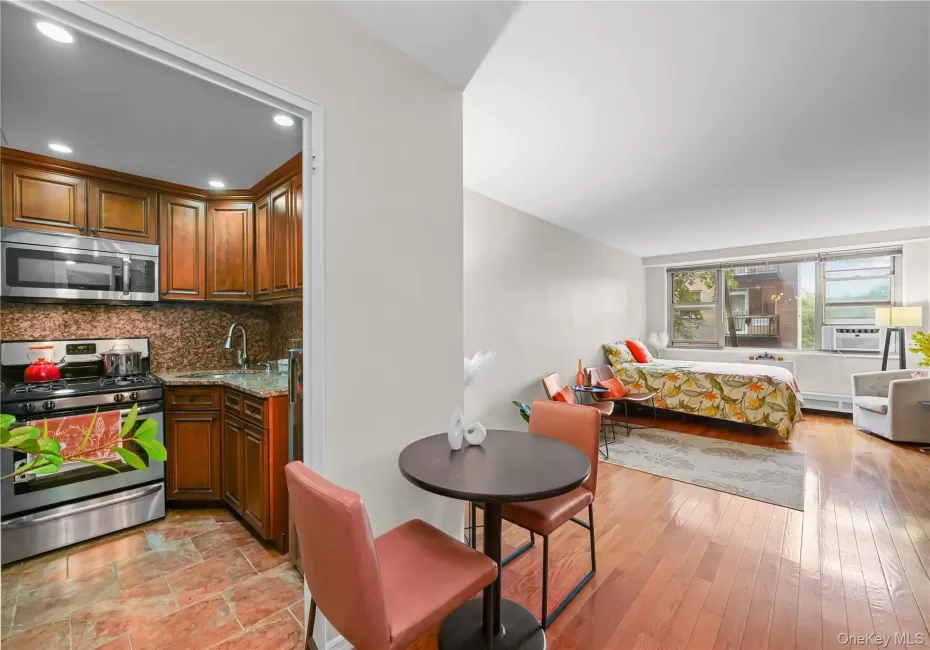 Kitchen featuring wood cabinetry, stainless steel appliances, and granite countertops Kitchen featuring wood cabinetry, stainless steel appliances, and granite countertops