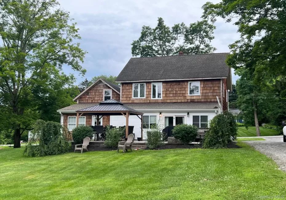 View of front of property featuring a gazebo, a front lawn, and a shingled roof View of front of property featuring a gazebo, a front lawn, and a shingled roof