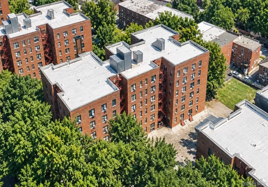 Brick multi-story buildings featuring multiple windows and exterior fire escapes Brick multi-story buildings featuring multiple windows and exterior fire escapes