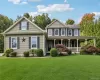Gable rooflines and green siding with black louvered shutters Gable rooflines and green siding with black louvered shutters