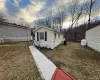 View of side of home featuring a lawn View of side of home featuring a lawn