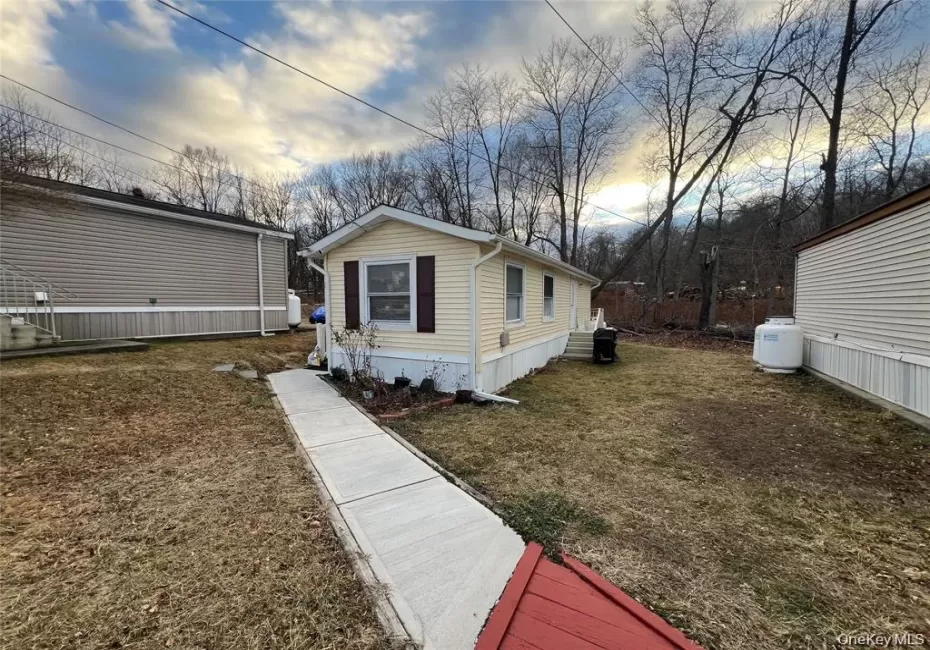 View of side of home featuring a lawn View of side of home featuring a lawn