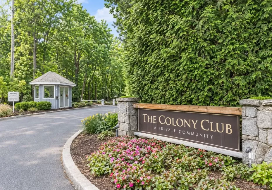 Virtually Edited. Entry sign "The Colony Club a Private Community" with stone pillars and mature evergreen landscaping. Virtually Edited. Entry sign "The Colony Club a Private Community" with stone pillars and mature evergreen landscaping.