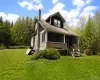 Two-story home with a screened-in porch and wood siding Two-story home with a screened-in porch and wood siding