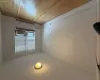 Wood-finish flooring, white walls, and a window with blinds Wood-finish flooring, white walls, and a window with blinds