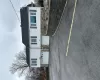 View of front facade with aphalt driveway, roof with shingles, and an attached garage View of front facade with aphalt driveway, roof with shingles, and an attached garage