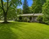 Expansive front lawn with mature trees and established landscaping Expansive front lawn with mature trees and established landscaping