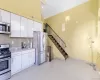 Kitchenette featuring stainless steel appliances, white cabinetry, and light-toned flooring Kitchenette featuring stainless steel appliances, white cabinetry, and light-toned flooring