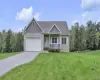 Siding exterior with a covered porch, attached garage, and a paved driveway Siding exterior with a covered porch, attached garage, and a paved driveway
