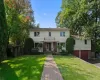 Welcome to 16 Cadillac Drive. Two-story residence with a brick paver walkway, mature trees, and a front lawn. Welcome to 16 Cadillac Drive. Two-story residence with a brick paver walkway, mature trees, and a front lawn.