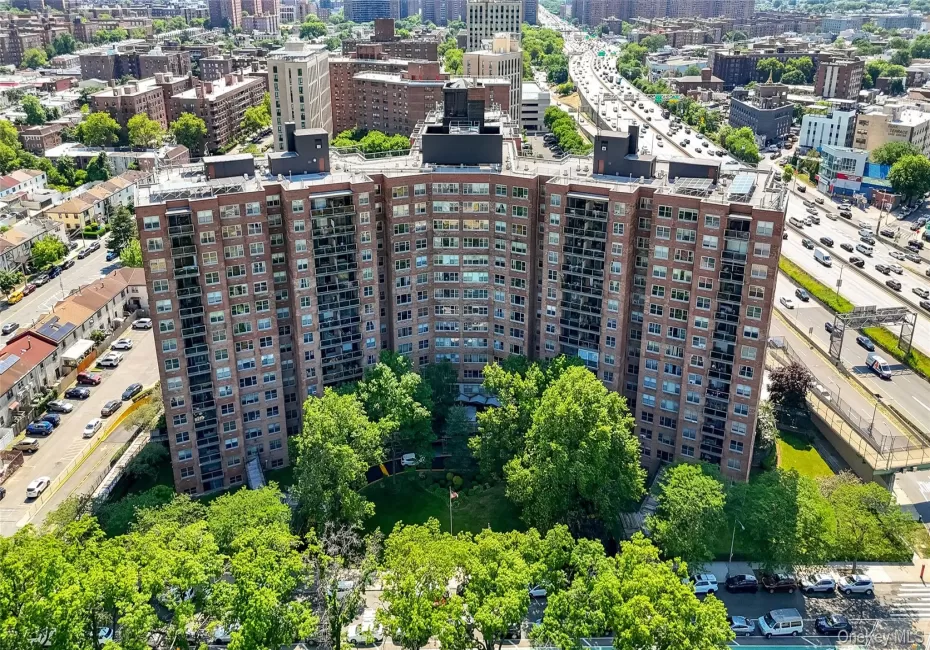 Multi-story building with a brick exterior, multiple balconies, and integrated green spaces Multi-story building with a brick exterior, multiple balconies, and integrated green spaces