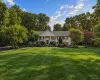 Expansive front lawn with mature trees and established landscaping Expansive front lawn with mature trees and established landscaping
