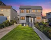 Modern facade. with dual entry doors, manicured lawn, and paved driveway Modern facade. with dual entry doors, manicured lawn, and paved driveway