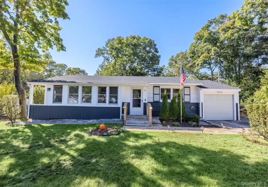 Single-story residence featuring a two-tone exterior, attached garage, and a front entrance with steps Single-story residence featuring a two-tone exterior, attached garage, and a front entrance with steps
