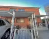 View of front of home featuring brick siding, a porch, a fenced front yard, and a gate View of front of home featuring brick siding, a porch, a fenced front yard, and a gate
