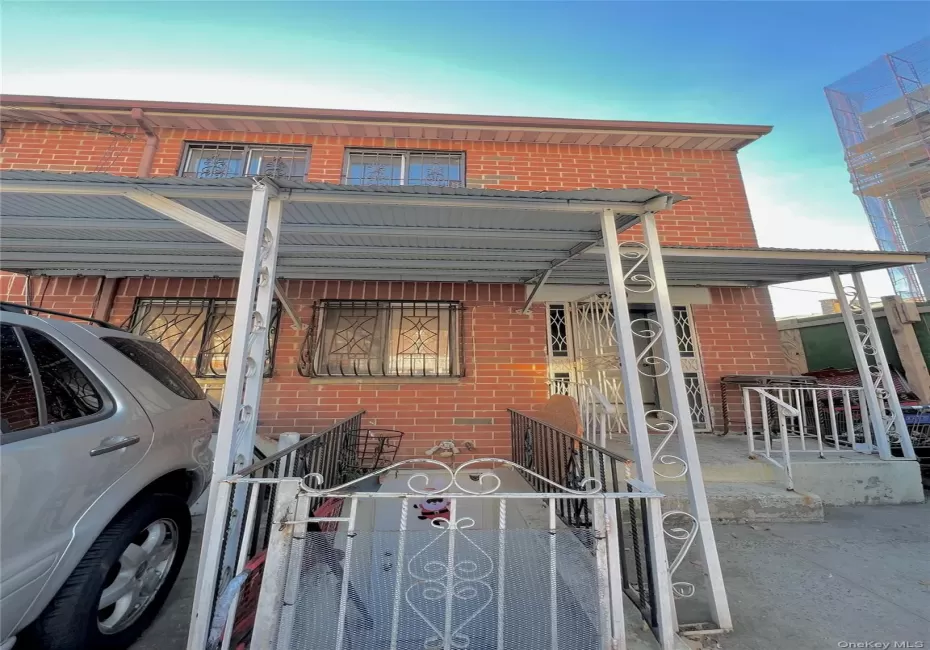 View of front of home featuring brick siding, a porch, a fenced front yard, and a gate View of front of home featuring brick siding, a porch, a fenced front yard, and a gate