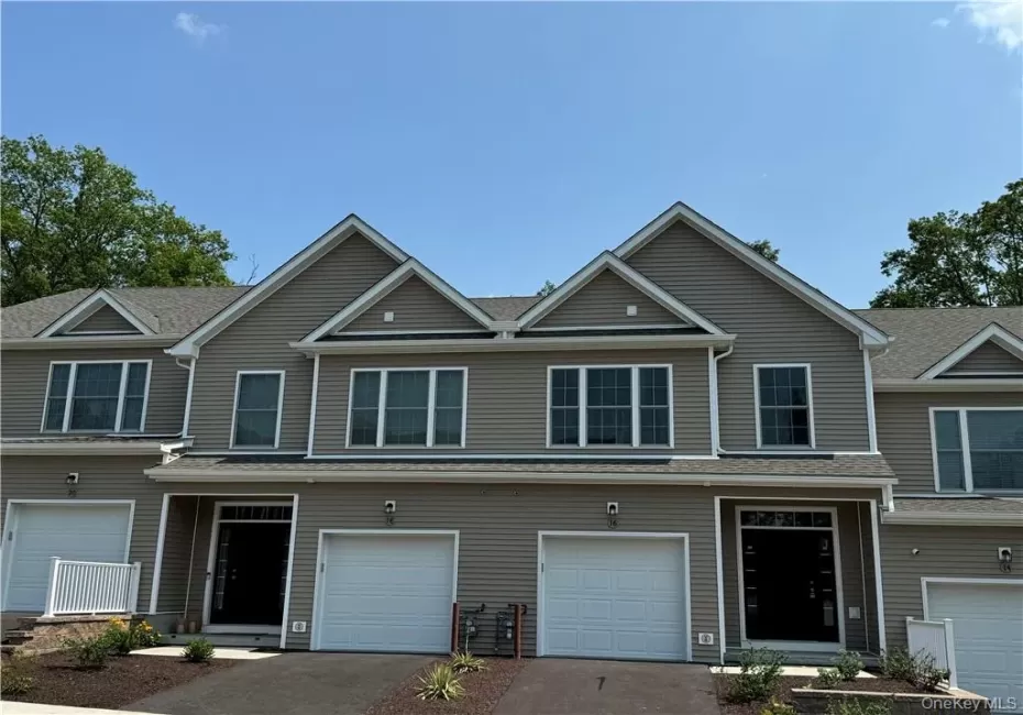 View of property featuring a garage View of property featuring a garage