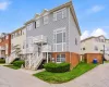 Multi-level townhouse with brick and siding exterior, and dedicated entryways Multi-level townhouse with brick and siding exterior, and dedicated entryways