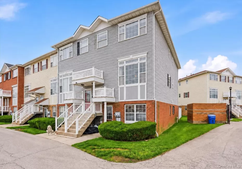 Multi-level townhouse with brick and siding exterior, and dedicated entryways Multi-level townhouse with brick and siding exterior, and dedicated entryways