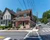View of front of house featuring a shingled roof and a chimney View of front of house featuring a shingled roof and a chimney