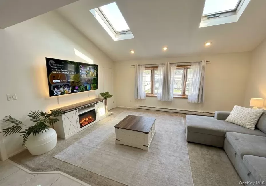 Living room with vaulted ceilings and skylights Living room with vaulted ceilings and skylights