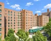 Multi-story brick exterior featuring a recessed building entrance and ground-level commercial storefront Multi-story brick exterior featuring a recessed building entrance and ground-level commercial storefront