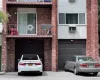 View of front of home featuring a balcony and a garage View of front of home featuring a balcony and a garage