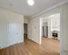 Unfurnished living room featuring light wood-style flooring and baseboards Unfurnished living room featuring light wood-style flooring and baseboards