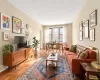 Large living room with oversized windows and hardwood floors that need TLC Large living room with oversized windows and hardwood floors that need TLC