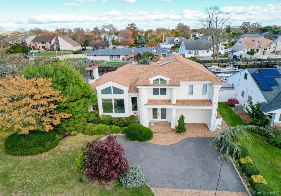 View of front of house with a residential view, decorative driveway, and stucco siding View of front of house with a residential view, decorative driveway, and stucco siding