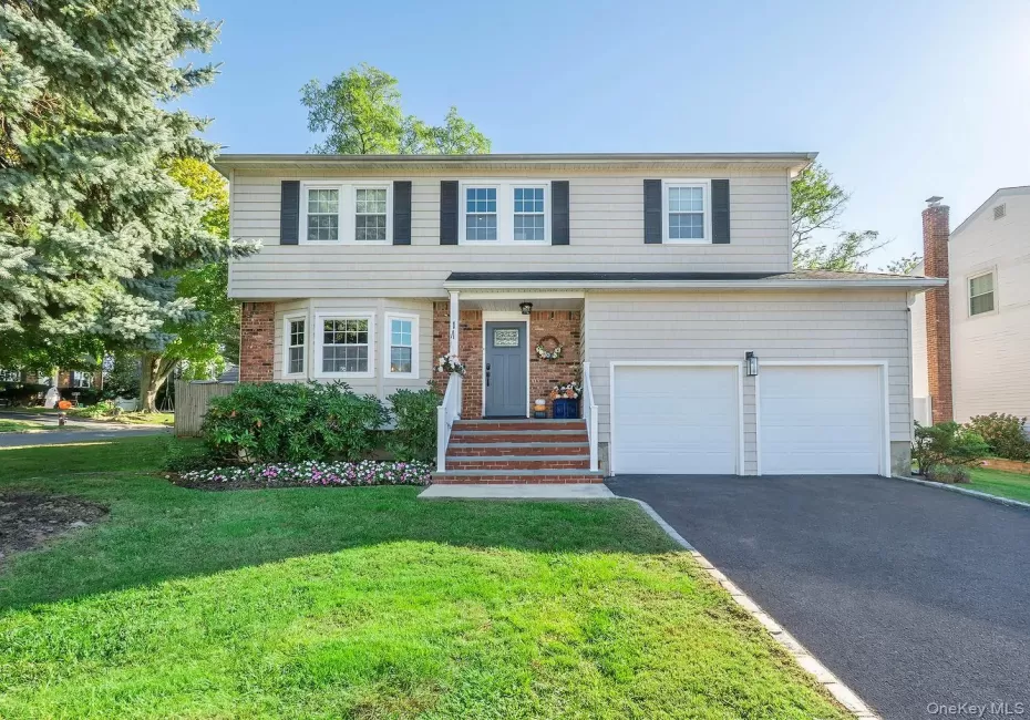 Front of home, driveway and 2 car garage with high ceilings Front of home, driveway and 2 car garage with high ceilings